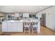 Modern kitchen featuring stainless steel appliances, white cabinets, and a large island at 5404 W Rowland Pl, Littleton, CO 80128