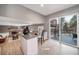 Open living space featuring a fireplace, built-in bar, and sliding glass doors to the backyard at 5404 W Rowland Pl, Littleton, CO 80128