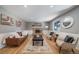 Cozy living room featuring a fireplace, stylish furniture, and natural light from a large window at 5404 W Rowland Pl, Littleton, CO 80128