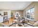 Bright living room featuring modern decor, ample seating, and an open layout to the kitchen at 5404 W Rowland Pl, Littleton, CO 80128