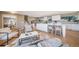 Open floor plan blends living, dining, and kitchen areas, with modern decor, hardwood flooring, and natural light at 5404 W Rowland Pl, Littleton, CO 80128