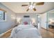 Relaxing bedroom with ceiling fan, comfortable bed, and ample natural light at 5404 W Rowland Pl, Littleton, CO 80128