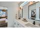 Modern bathroom featuring dual sinks, sleek fixtures, and an open doorway to the bedroom at 1301 Osceola St, Denver, CO 80204