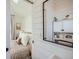 The bathroom features shiplap walls and a modern mirror reflecting the adjacent bedroom, creating an open feel at 1301 Osceola St, Denver, CO 80204
