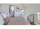 Cozy bedroom with patterned bedding and doorway to the bathroom at 1301 Osceola St, Denver, CO 80204