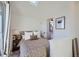 Cozy bedroom with patterned bedding, bedside table, and doorway to the bathroom at 1301 Osceola St, Denver, CO 80204