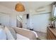 Bright bedroom featuring closet doors, and a comfortable bed with neutral bedding at 1301 Osceola St, Denver, CO 80204
