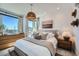 Bright bedroom featuring large windows, stylish decor, and a comfortable bed with neutral bedding at 1301 Osceola St, Denver, CO 80204