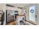 Well-lit kitchen featuring stainless steel appliances, white cabinetry, and a charming center island with a wooden countertop at 1301 Osceola St, Denver, CO 80204