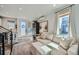 Inviting living area showcasing a cozy sofa, stylish ottoman, and abundant natural light streaming through large windows at 1301 Osceola St, Denver, CO 80204