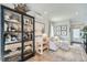 Bright living room with hardwood floors, neutral furniture, a stylish bookcase, and decorative accents creating a cozy atmosphere at 1301 Osceola St, Denver, CO 80204