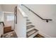 Interior staircase with modern railing and decorative rug runners on the wooden steps at 1301 Osceola St, Denver, CO 80204
