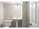 Neat bathroom with a pedestal sink, toilet, and a simple, clean design at 9472 E 109Th Pl, Commerce City, CO 80640