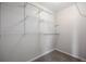 Walk-in closet with white wire shelving and neutral carpet, offering ample storage space at 9472 E 109Th Pl, Commerce City, CO 80640
