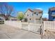 Beautifully fenced home featuring a neat lawn, attached garage, and a lovely flowering tree near the entrance at 9472 E 109Th Pl, Commerce City, CO 80640