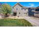 Charming home with a well-kept lawn, integrated garage, and a blossoming tree enhancing its curb appeal at 9472 E 109Th Pl, Commerce City, CO 80640
