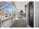 Covered front porch offers an outdoor living space with views of the neighborhood at 9472 E 109Th Pl, Commerce City, CO 80640