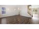 Open living room features sleek hardwood floors and staircase, perfect for entertaining at 9472 E 109Th Pl, Commerce City, CO 80640