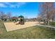 Colorful playground with slides, swings, and climbing structures, surrounded by a wood chip safety surface at 9472 E 109Th Pl, Commerce City, CO 80640