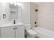 A clean, updated bathroom features tile walls, a tub, and a white vanity with dark fixtures, providing a modern look at 1347 S Crystal Way, Aurora, CO 80012