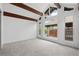 A bright bedroom features carpeted floors, wood beams, large windows, and white walls, creating a calming space at 1347 S Crystal Way, Aurora, CO 80012