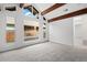 A bright bedroom features carpeted floors, wood beams, large windows, and white walls, creating a calming space at 1347 S Crystal Way, Aurora, CO 80012
