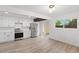 A spacious kitchen features modern appliances, white cabinets, and hardwood floors with ample countertop space at 1347 S Crystal Way, Aurora, CO 80012