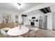 Elegant kitchen with stainless steel appliances, white cabinetry, and a dining area perfect for Gathering meals at 1347 S Crystal Way, Aurora, CO 80012