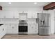 Modern kitchen with white cabinets, stainless steel appliances and countertop for easy cooking at 1347 S Crystal Way, Aurora, CO 80012