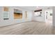 Spacious, light-filled living room featuring sleek hardwood floors and large windows offering scenic views at 1347 S Crystal Way, Aurora, CO 80012