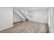 A spacious living room boasts hardwood-style floors, bright lighting, and a staircase to the side at 1347 S Crystal Way, Aurora, CO 80012