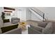 Cozy living room with comfortable seating, stylish rug, and convenient access to the staircase and kitchen at 1347 S Crystal Way, Aurora, CO 80012