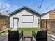 Backyard with white detached garage, an outdoor movie screen, and seating at 3640 Lipan St, Denver, CO 80211