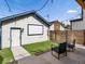 Backyard with white detached garage, an outdoor movie screen, and seating at 3640 Lipan St, Denver, CO 80211