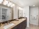 Modern bathroom with double vanity, stylish mirrors, and neutral tile at 3640 Lipan St, Denver, CO 80211