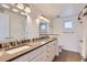 Modern bathroom with double sinks, updated cabinetry, contemporary fixtures, and decorative tile accents at 3640 Lipan St, Denver, CO 80211