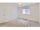 Light and airy bedroom features a plush carpet, white walls, modern trim, and a bright window at 3640 Lipan St, Denver, CO 80211