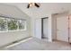Bright bedroom featuring neutral carpeting, white walls, a ceiling fan, and a closet at 3640 Lipan St, Denver, CO 80211