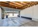 A spacious, unfinished garage with concrete floors and exposed wood rafters at 3640 Lipan St, Denver, CO 80211