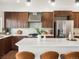 Modern kitchen boasts stainless steel appliances, sleek cabinetry, and a spacious island, perfect for culinary enthusiasts at 3640 Lipan St, Denver, CO 80211