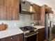 Modern kitchen features stainless steel range, hood, appliances, and wood cabinets at 3640 Lipan St, Denver, CO 80211