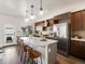 Bright kitchen with a large island, stainless steel refrigerator, and modern pendant lighting at 3640 Lipan St, Denver, CO 80211