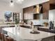 Modern kitchen featuring a large island, stainless steel appliances, and sleek wooden cabinets at 3640 Lipan St, Denver, CO 80211