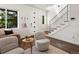 Bright living room with hardwood floors, modern staircase, and cozy seating area at 3640 Lipan St, Denver, CO 80211
