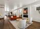 Spacious open-concept living area with fireplace, stylish seating, and hardwood floors offers a modern and inviting atmosphere at 3640 Lipan St, Denver, CO 80211