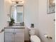 Stylish powder room featuring modern fixtures, textured tile wall, and sleek vanity at 3640 Lipan St, Denver, CO 80211