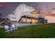 Spacious backyard with a multi-level deck, hot tub, lounge furniture, and lush green lawn at 1601 Mariah Ln, Erie, CO 80516