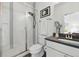 Modern bathroom featuring glass enclosed shower, dark accents, and tile surround at 1601 Mariah Ln, Erie, CO 80516