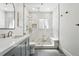 Modern bathroom features a frameless glass shower, neutral tiling, and a built-in bench for added convenience at 1601 Mariah Ln, Erie, CO 80516