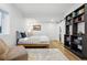 Serene bedroom with hardwood floors, built-in shelves, and minimalist decor at 1601 Mariah Ln, Erie, CO 80516
